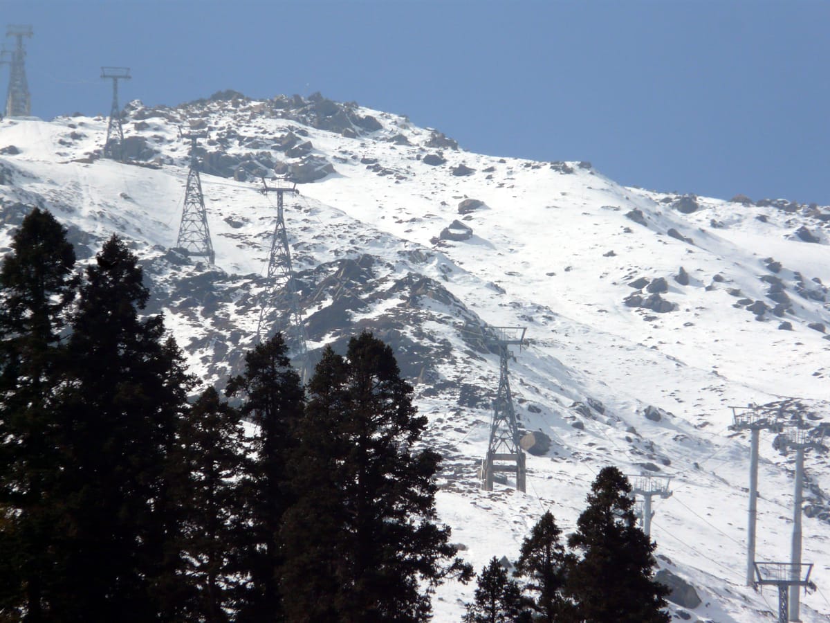 Gulmarg Gondola towers among snow and pines