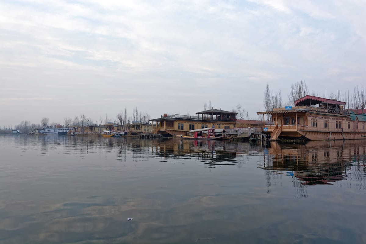 Houseboats at rest in the soft morning haze